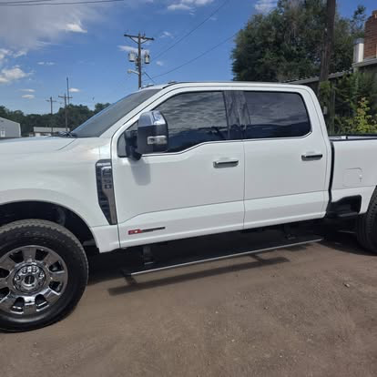 White Ford Super Duty crew cab with matched tint all around