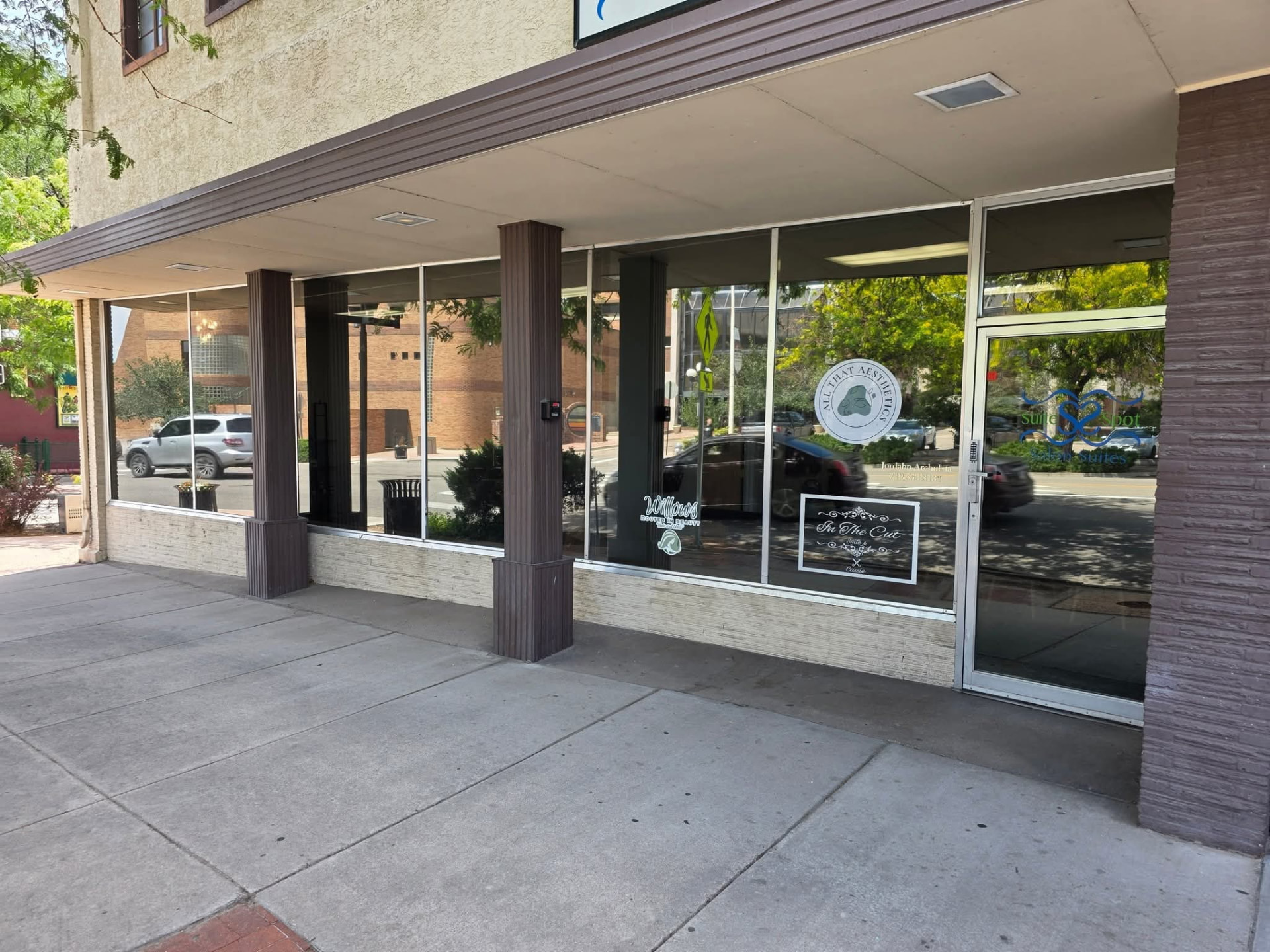 Downtown salon suites storefront with tinted display windows