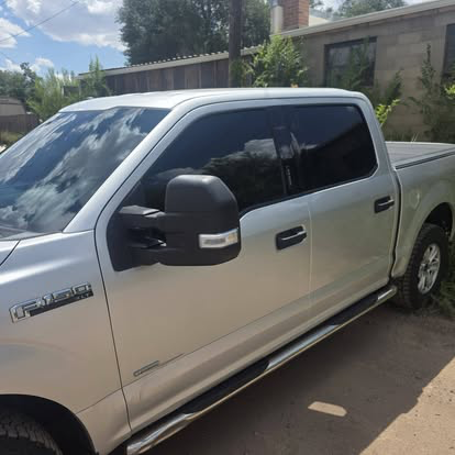 Silver Ford F-150 crew cab with dark tinted windows