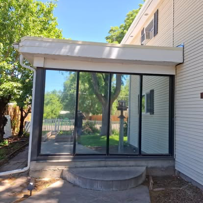Tinted sunroom glass on a Cañon City home, cutting glare on a sunny day