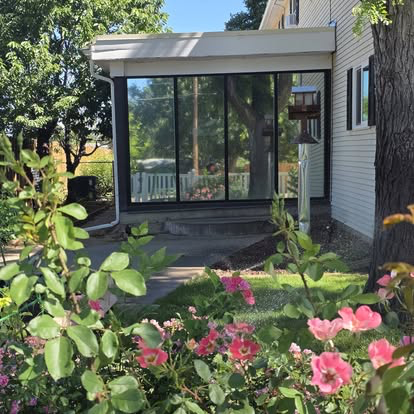 Freshly tinted sunroom windows viewed from the garden of a Cañon City home