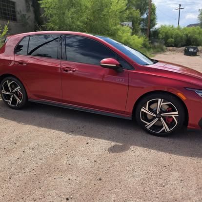 Red Volkswagen Golf GTI with fresh window tint
